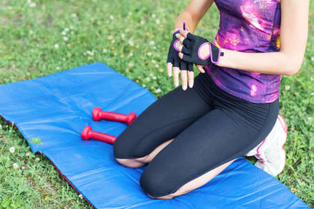Sporty girl on the stadium. Football stadium. Slim sporty fitness woman. Bottle Shaker protein. Social media and fitness concept. Toned image.の写真素材