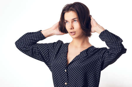 Beautiful young woman. Girl in casual clothes on a light background. Girl in jeans. Sexy girl. Toned imageの写真素材