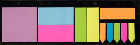 Stickers on a dark background. Bright colored stickers on dark board.