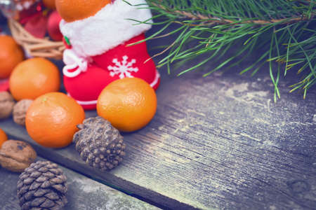Branches of a Christmas tree on old boards. Christmas background. Christmas Socks. Christmas decorations. New Year background. Xmax background. Toned image.の写真素材