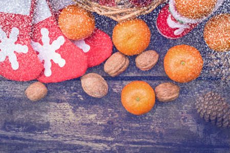 Christmas decorations lay in a wicker basket. Merry Christmas. Christmas background. Christmas Socks. 2017 year. Christmas decorations. New Year background. Xmax background. Toned image. Snow falls.の写真素材