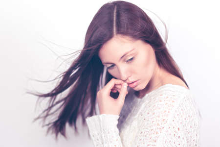 Beautiful young girl on a light background