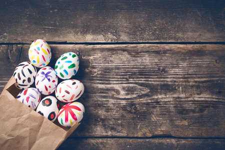 Easter bunny in a paper bag on old boardsの写真素材