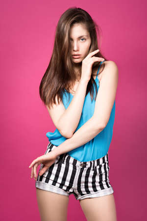 Beautiful girl on a pink backgroundの写真素材