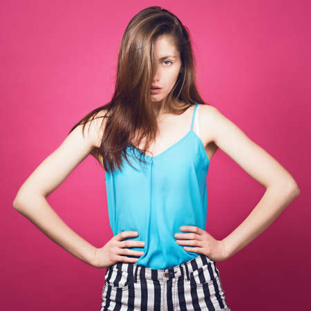 Beautiful girl on a pink backgroundの写真素材