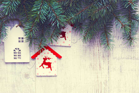 Christmas background. Christmas trees and Christmas decorations are on old light boards. Fir branches. Handmade decorations. Toned image. Space for text.の写真素材
