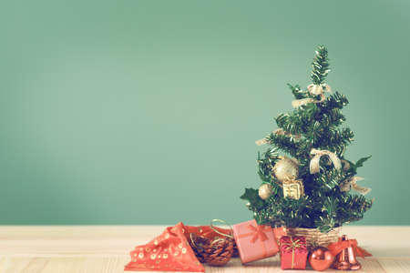Festive Christmas tree stands on light boards. Christmas background. Christmas decorations on a green background. Space for text. New Year's background. Toned image.の写真素材