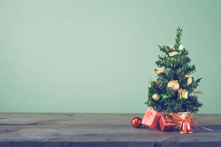Festive Christmas tree stands on dark boards. Christmas background. Christmas decorations on a green background. Space for text. New Year's background. Toned image.の写真素材