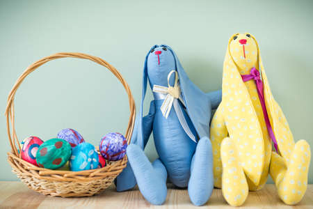 Two easter bunnies on a wooden table