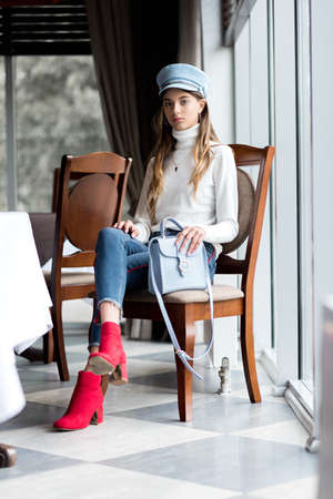 Photo of a beautiful girl in the interior of the restaurant