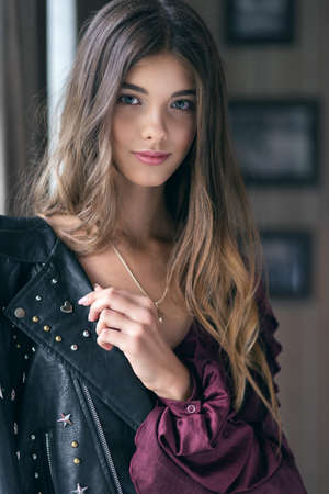 Young beautiful girl in a leather jacket