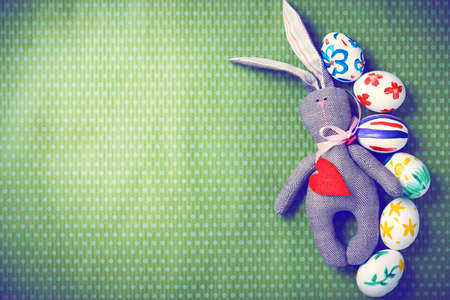 Painted Easter eggs on a green background with white polka dots. Toned image. Beautiful holiday card. Space for text. Happy easter.の写真素材