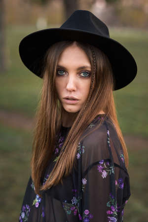 Beautiful brunette in casual wear and hat.の写真素材