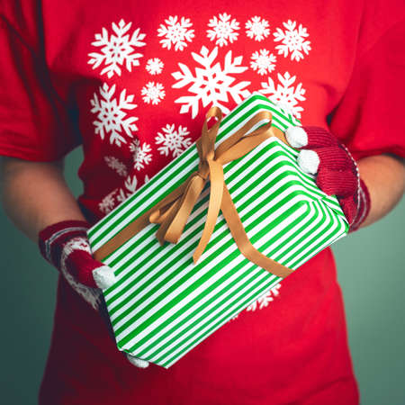 Girl holding a box with a gift for Christmas 2019.の写真素材