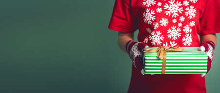 Girl holding a box with a gift for Christmas 2019.の写真素材