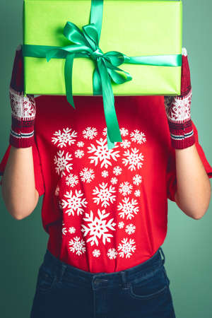 Girl holding a box with a gift for Christmas 2019.の写真素材