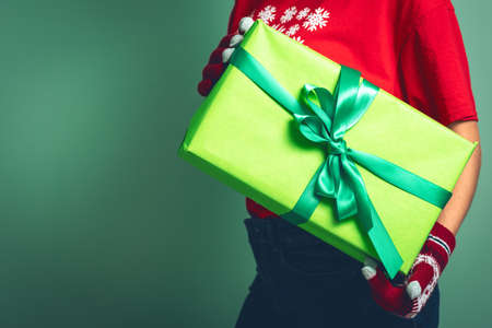 Girl holding a box with a gift for Christmas 2019.の写真素材