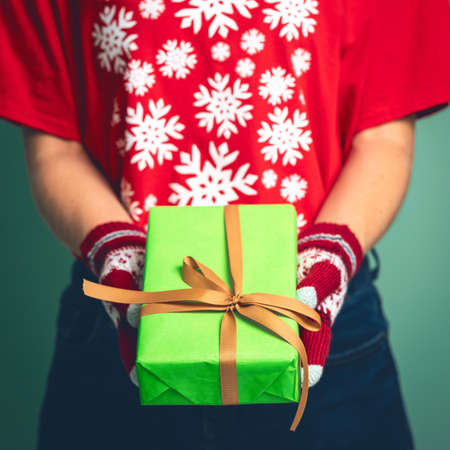 Girl holding a box with a gift for Christmas 2019.の写真素材