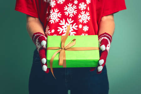 Girl holding a box with a gift for Christmas 2019.の写真素材
