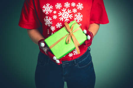 Girl holding a box with a gift for Christmas 2019.の写真素材