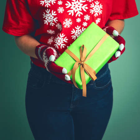 Girl holding a box with a gift for Christmas 2019.の写真素材