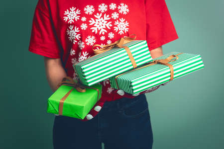 Girl holding a boxes with a gift for Christmas 2019.の写真素材