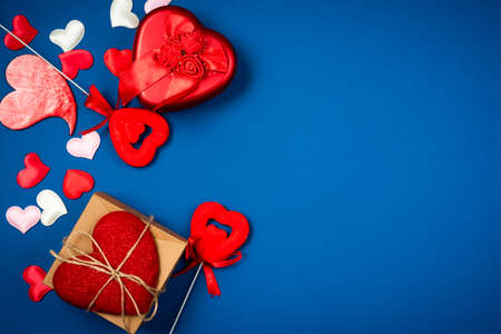 Red heart with a gift to Valentine's Day on a beautiful blue background. Heart pendant. Space for text. Red heart. Valentine Day.の写真素材