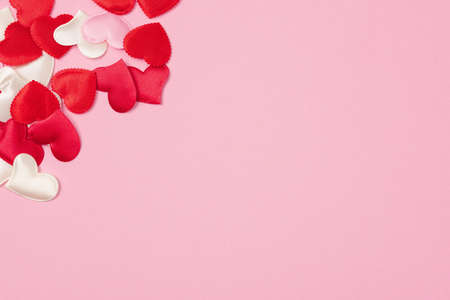 Red hearts for Valentine's day lie on a beautiful pink background. Heart pendant. Space for text. Red heart. Valentine Day.の写真素材