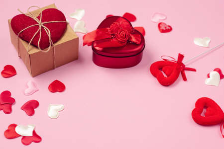 Red hearts with a gift to Valentine's Day on a beautiful pink background. Heart pendant. Space for text. Red heart. Valentine Day.の写真素材