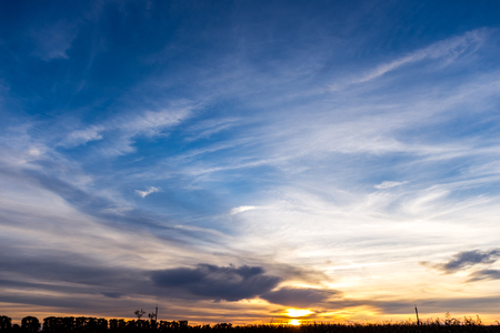The blue saturated sky is decorated with sunsetの写真素材