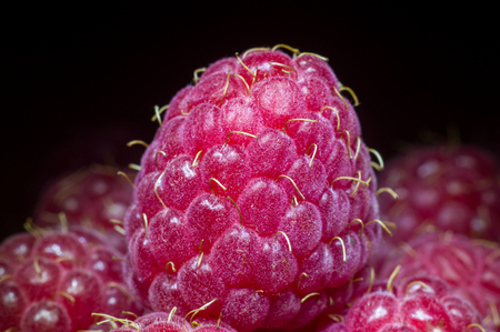 Macro fruit raspberries on a dark background