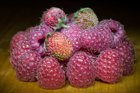 fruit strawberries and raspberries on a dark backgroundの写真素材