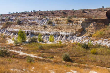 Bizarre figures carved in clay sands in an old quarry. Zaporozhye region, Ukraine. September 2017の写真素材