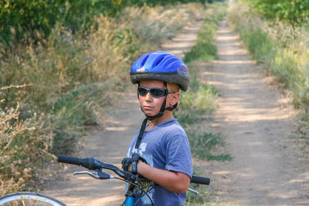 A notable cyclist rests before a long road in the Ukrainian steppe near the town of Pologi. Zaporozhye region, Ukraine. August 2009のeditorial素材