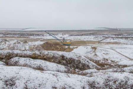 Snow-covered winter clay quarry in the Zaporozhye region of Ukraine. February 2018