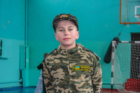 At the festival, the boy poses in the form of a stylized form of the Ukrainian army. Zaporozhye...