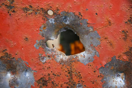 Hole from the canister of the twelfth caliber of a hunting smooth-bore gun in a steel plate 3 mm thickの写真素材