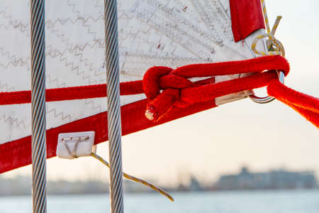 Attaching the sail of the yacht. Black Sea, Odessa, Ukraine. September 2014の写真素材