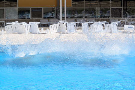 big water splash and inverted chaise lounges at pool partyの写真素材