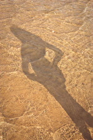 shadow of a slender young girl in the waterの写真素材