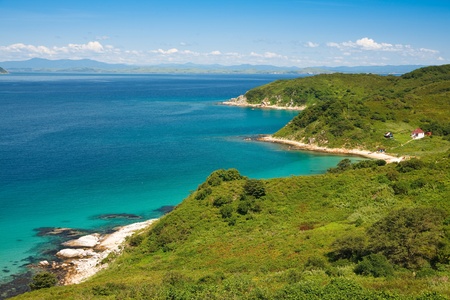 waterscape, emerald forest and marine blue combines the thin strip of beachの写真素材