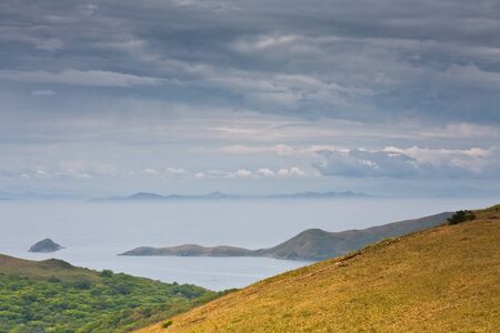 Russian Primorye seabank. near Vladivostok. Andreevka village.The mysterious island in the blue seaの写真素材
