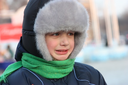 Winter portrait of a young boy with blue eyesの写真素材