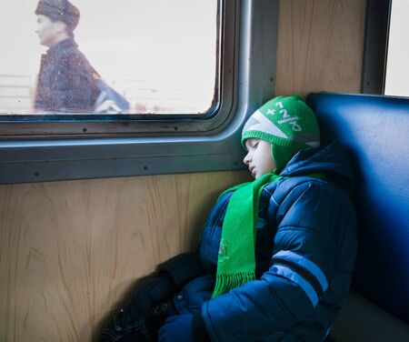 Winter portrait of a young boy with blue eyesの写真素材