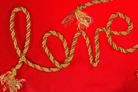 love the inscription in gold thread on red satinの写真素材