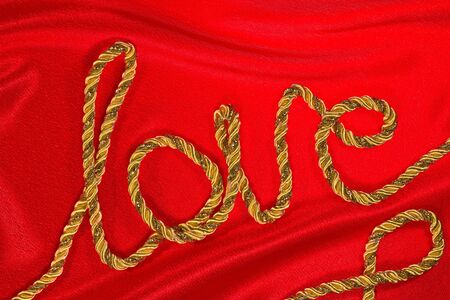 love the inscription in gold thread on red satinの写真素材