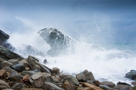 storm waves rolled on rocky shoreの写真素材