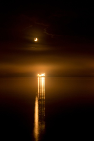 the ship is at anchor off the coast ofの写真素材