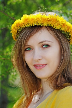 portrait of a beautiful blonde with flowers in her hairの写真素材