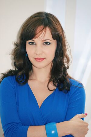 portrait of a girl in a blue dress in the white studioの写真素材